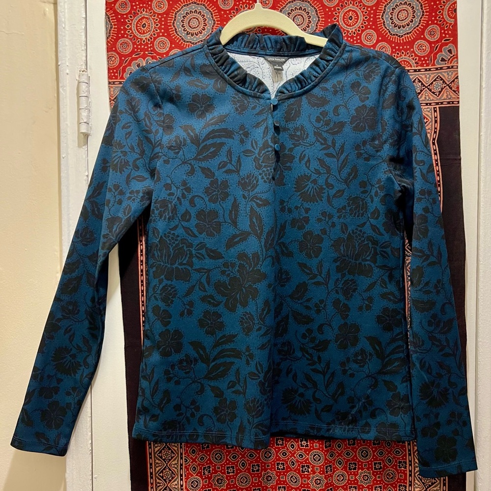 Size small Ann Taylor blue and black floral printed long sleeved blouse.